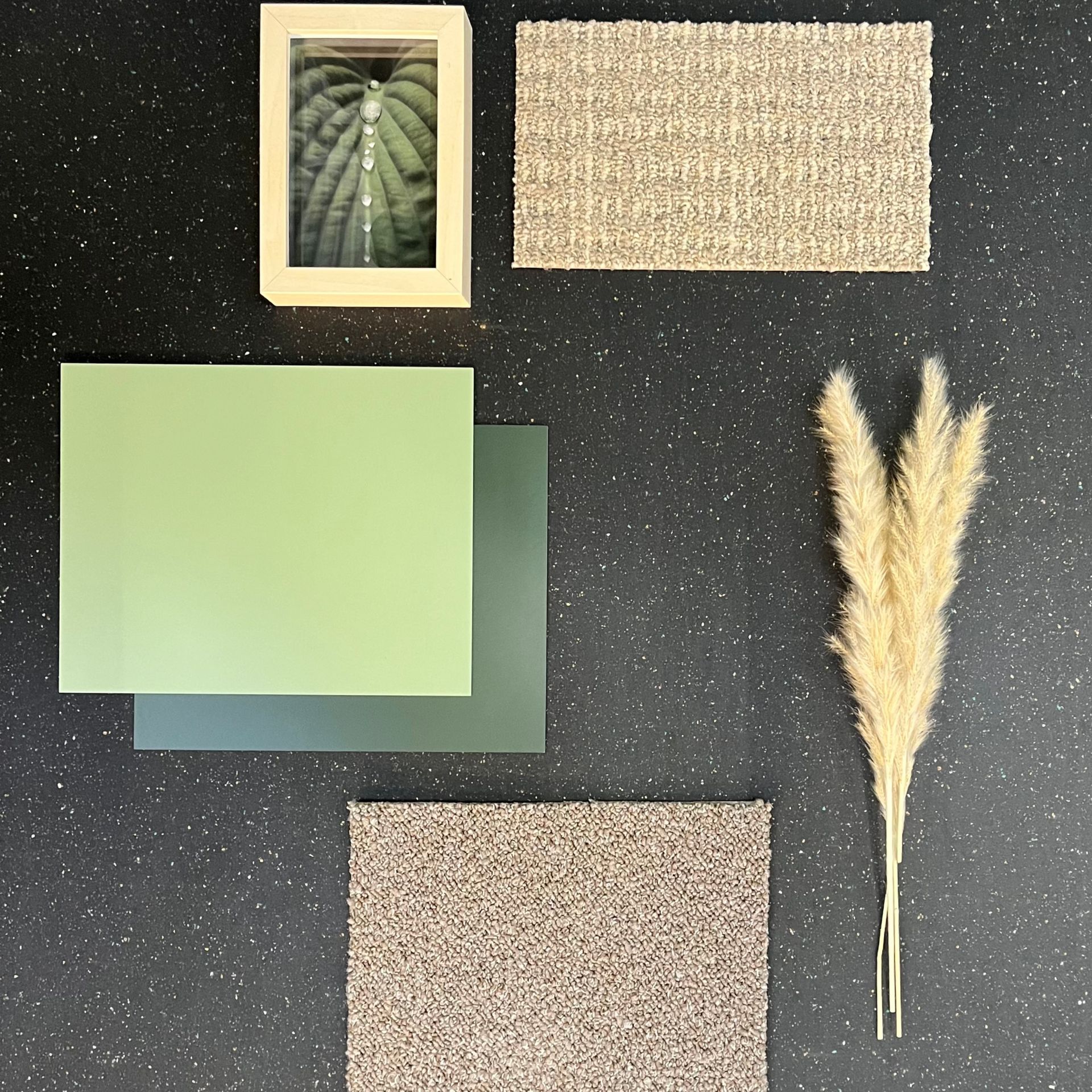 nora rubber tiles with carpet rectangle, wheat, and framed plant over black rubber background